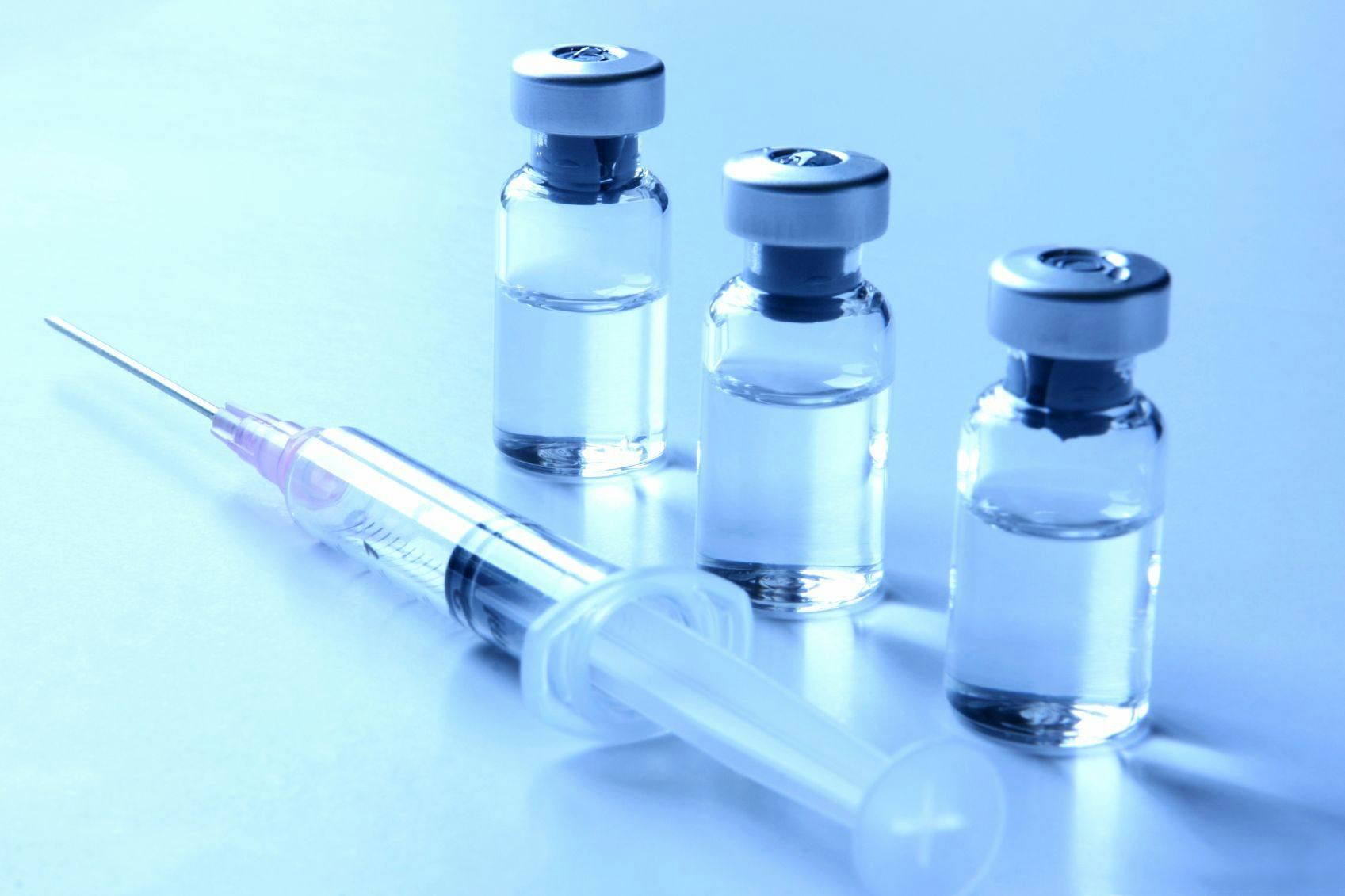 Image of three vials of treatment and a syringe.