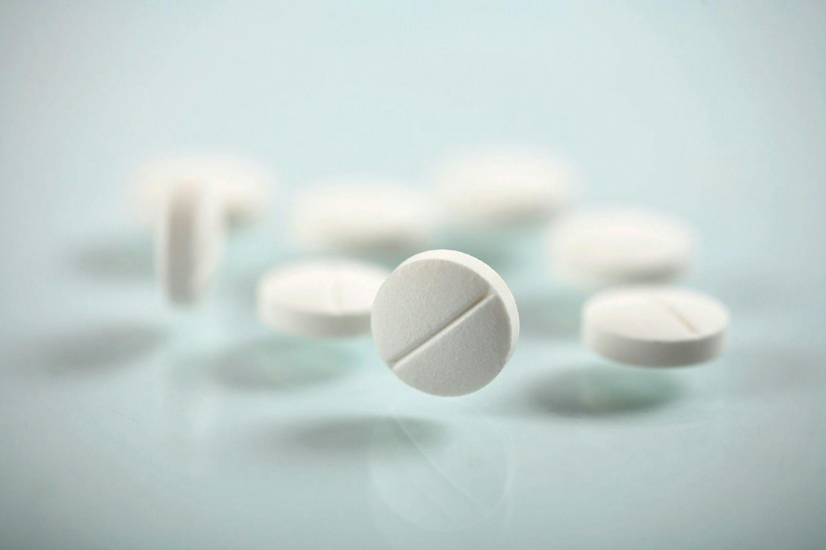 Image of a pile of white circular pills.